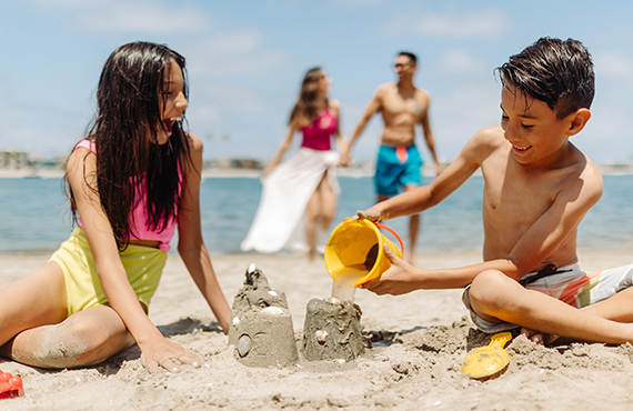 Family enjoying beach time on the shores of Mission Bay at the Bahia Resort